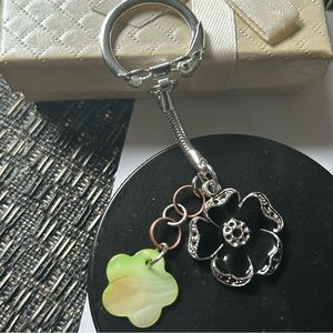 Floral keychain or bag charm, green, black and silver charms